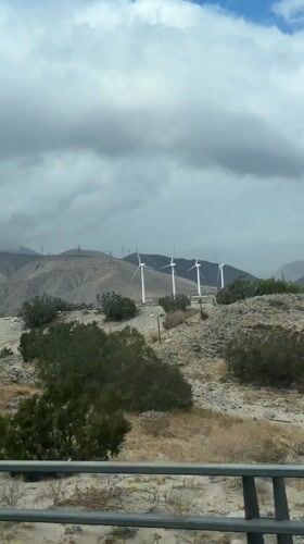 Wind turbines filmed against cloudy skies near Palm Springs