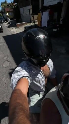 Scooter passenger films selfie video in Kediri, Indonesia