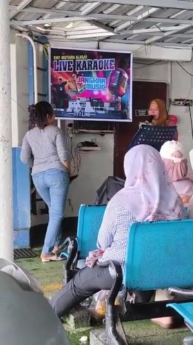 Ferry passengers enjoy live karaoke session during Indonesian boat journey