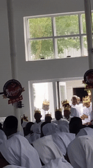 Religious ceremony with white-robed congregation held in Anantigha