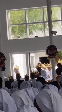 Religious ceremony with white-robed congregation held in Anantigha
