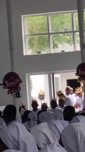 Religious ceremony with white-robed congregation held in Anantigha