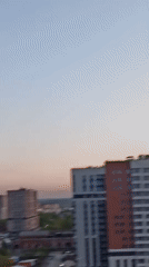 Dark smoke plume observed rising from city skyline