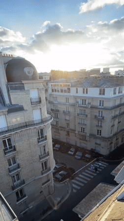 Golden hour over Paris rooftops, seen from above