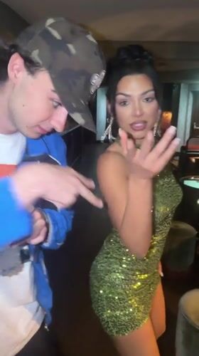 Woman in green sequined dress dances at Vienna bar