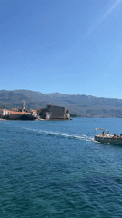 Woman sunbathes on rocks at Montenegro's Mogren Beach