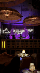 DJ performs at Miami Beach nightclub with purple lighting