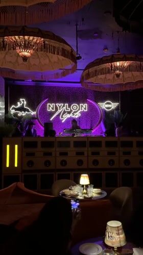 DJ performs at Miami Beach nightclub with purple lighting