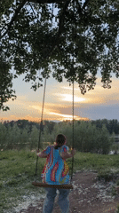 Families enjoy summer sunset evening along Kama River in Chaikovsky