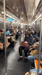 NYC subway passengers observed in typical evening commute scene
