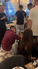 Group celebrates with cake in Bulgarian indoor gathering