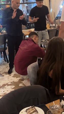 Group celebrates with cake in Bulgarian indoor gathering