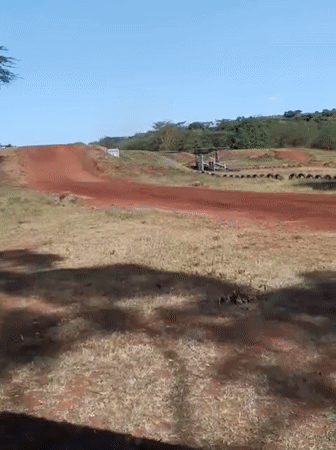 Dirt bike riders practice jumps at Nairobi motocross track