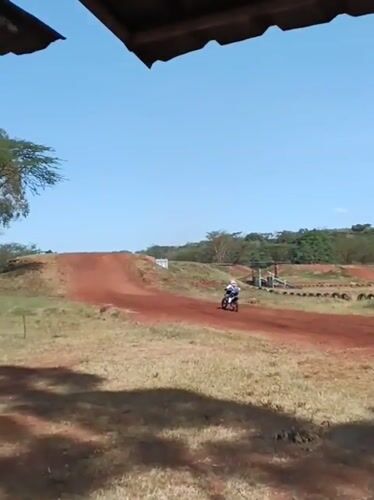Dirt bike riders practice jumps at Nairobi motocross track