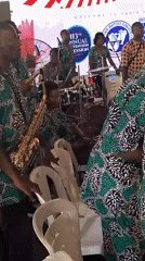 Community gathering features musical performance under tent venue