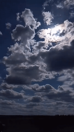 Mixed cloud formations documented over Russian countryside field