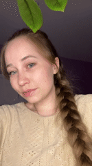 Woman with braided hair holds angel figurine in Saint Petersburg