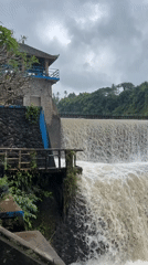 Flooded dam and truss bridge along a Klungkung river