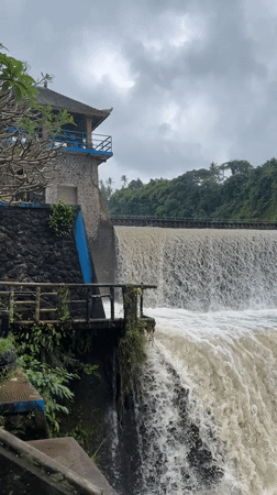 Flooded dam and truss bridge along a Klungkung river