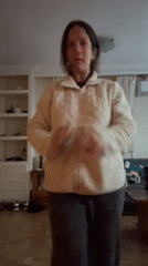 Woman dances to music in Madrid home during afternoon