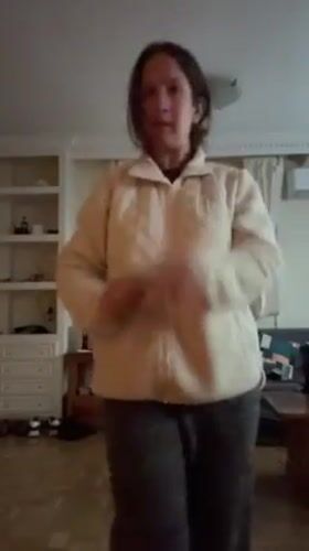 Woman dances to music in Madrid home during afternoon