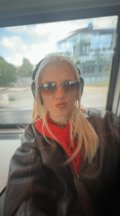 Train passenger in leather jacket observed by window