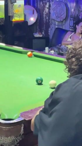 Late afternoon pool game at a neon-lit Phuket bar