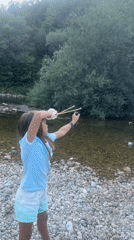Slingshot aimed on a rocky riverbank in Saint-Claude