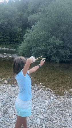 Slingshot aimed on a rocky riverbank in Saint-Claude