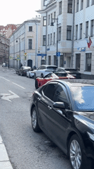 Red Ferrari departs Moscow street near historic Kadashi church