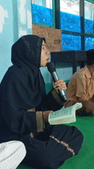 Religious text recited aloud from the floor in Mataram