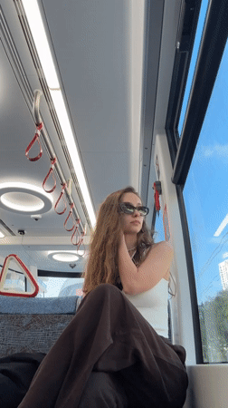 Woman rides tram in Bat Yam, Israel