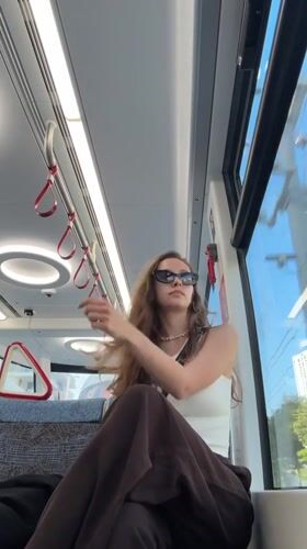 Woman rides tram in Bat Yam, Israel