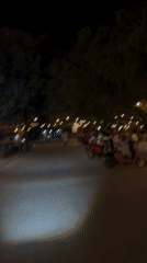 Couple shares nighttime electric scooter ride in Indonesia