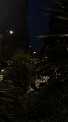 Orange-red full moon illuminates Milan night sky