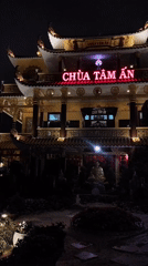 Buddhist Temple Complex Illuminated During Evening Hours in Da Lat