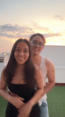 Couple poses for sunset photos on Puebla rooftop