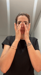 Woman performs evening skincare routine in Loures bathroom