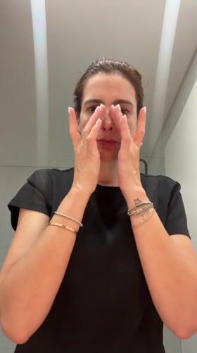 Woman performs evening skincare routine in Loures bathroom