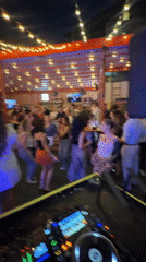 DJ performs at outdoor Moscow venue with dancing crowd