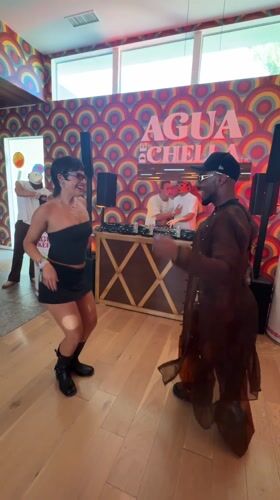 Indoor party with DJs, dancing, and service dog documented in Indio