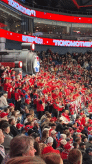 Packed hockey arena in Russia, red crowd, live game action