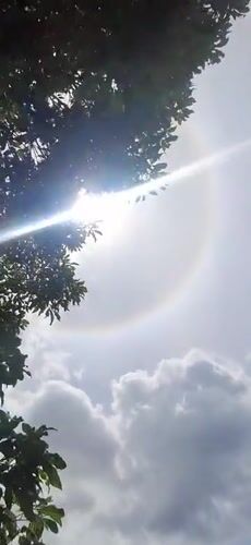 Children play as sun halo appears over Vallecito, Venezuela
