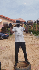 Person exercises with homemade weights on tire in Nigeria