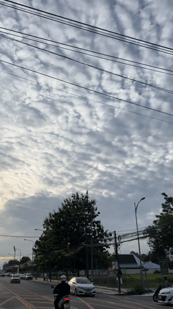 Wichit street under a dramatic cloud-filled morning sky