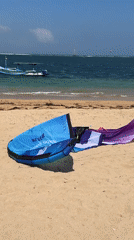 Kiteboarding and wing surfing session on a Bali beach