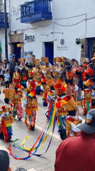 Traditional costume parade features children, Andean musicians near cathedral