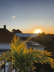 Sunset views captured over traditional rooftops in Kutuh, Indonesia