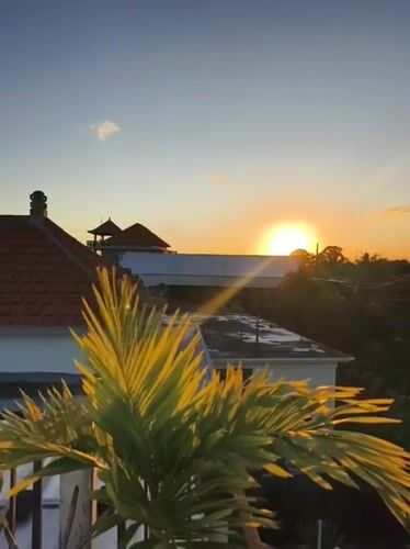 Sunset views captured over traditional rooftops in Kutuh, Indonesia