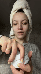 Woman applies eye patches during morning skincare routine in Russia